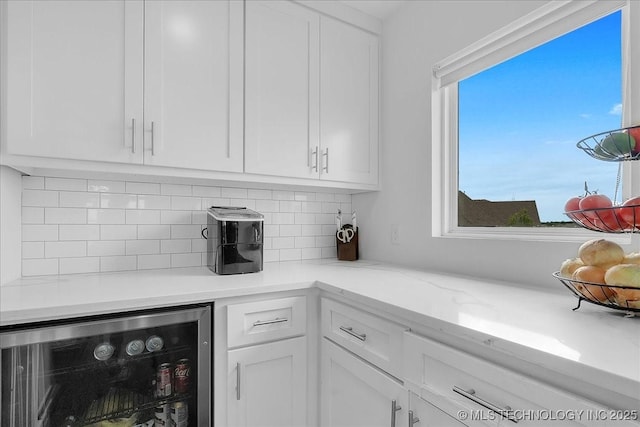 7107 E 88th St N, Owasso, OK 74055 - kitchen featuring wine cooler, white cabinets, and decorative backsplash