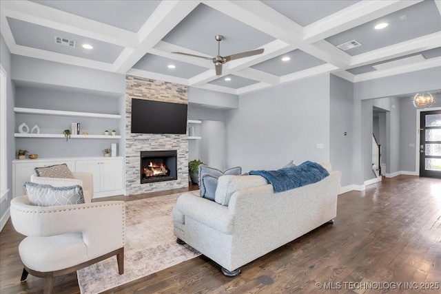 7107 E 88th St N, Owasso, OK 74055 - living area featuring coffered ceiling, dark wood-type flooring, a stone fireplace, ceiling fan, and beamed ceiling