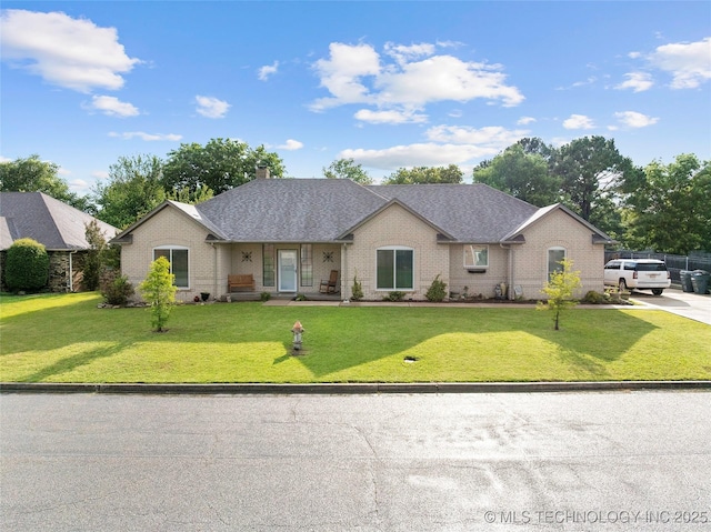 1507 Southern Hills Dr, Ardmore, OK 73401 - view of front of house featuring brick siding, a front lawn, and a chimney
