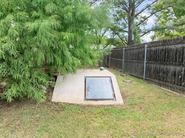 1507 Southern Hills Dr, Ardmore, OK 73401 - entry to storm shelter with a fenced backyard