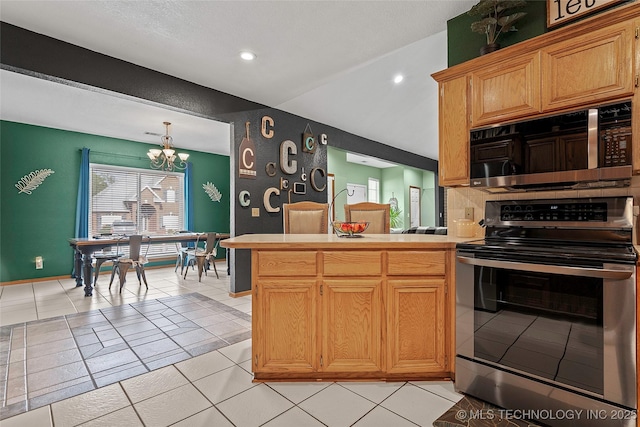 1507 Southern Hills Dr, Ardmore, OK 73401 - kitchen featuring stainless steel appliances, a chandelier, light countertops, a peninsula, and recessed lighting