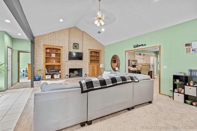 1507 Southern Hills Dr, Ardmore, OK 73401 - living area featuring vaulted ceiling, brick wall, built in features, ceiling fan, and a fireplace