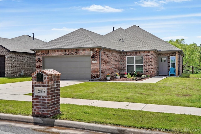 26806 E 143rd St S, Coweta, OK 74429 - french country home with brick siding, roof with shingles, a garage, concrete driveway, and a front lawn