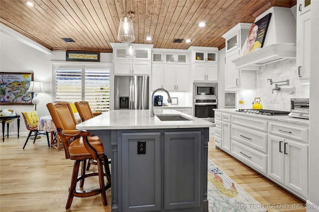 5314 E 126th St S, Bixby, OK 74008 - kitchen with stainless steel appliances, ventilation hood, wooden ceiling, white cabinets, and tasteful backsplash