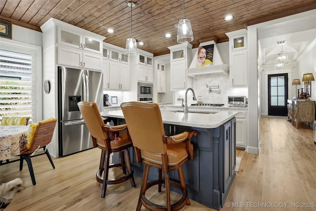 5314 E 126th St S, Bixby, OK 74008 - kitchen with appliances with stainless steel finishes, wooden ceiling, light countertops, white cabinetry, and extractor fan