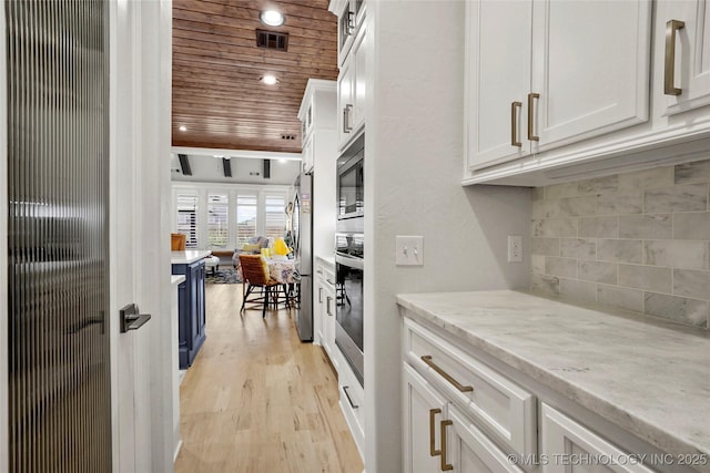 5314 E 126th St S, Bixby, OK 74008 - kitchen featuring wood ceiling, appliances with stainless steel finishes, white cabinets, decorative backsplash, and light wood-type flooring