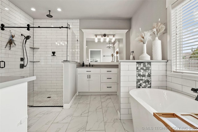 524 N 85th St, Broken Arrow, OK 74014 - bathroom featuring marble finish flooring, a freestanding bath, a stall shower, vanity, and recessed lighting