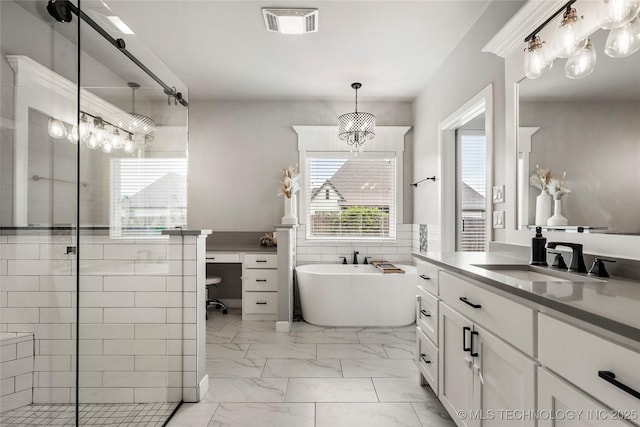 524 N 85th St, Broken Arrow, OK 74014 - full bathroom with marble finish floors, vanity, a freestanding tub, a stall shower, and a chandelier