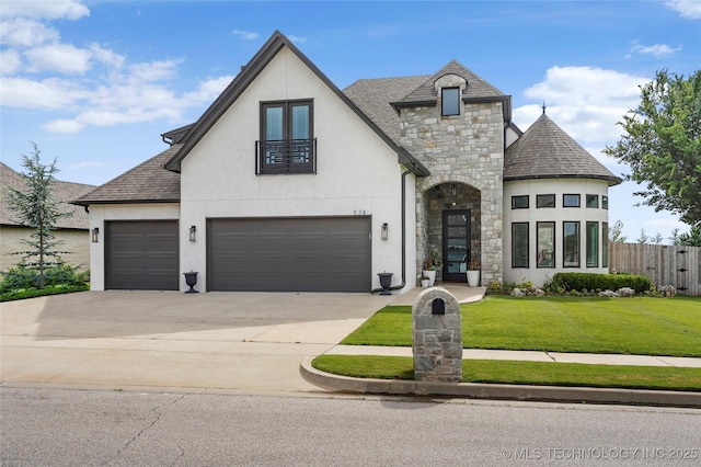 524 N 85th St, Broken Arrow, OK 74014 - french country inspired facade featuring stone siding, stucco siding, concrete driveway, roof with shingles, and an attached garage