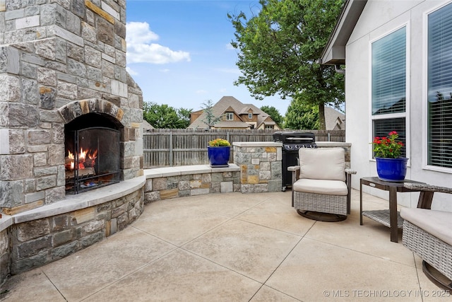 524 N 85th St, Broken Arrow, OK 74014 - view of patio featuring an outdoor stone fireplace and an outdoor kitchen