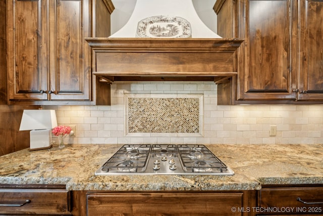 9545 E 108th St S, Bixby, OK 74133 - kitchen with stainless steel gas stovetop, tasteful backsplash, and dark brown cabinets