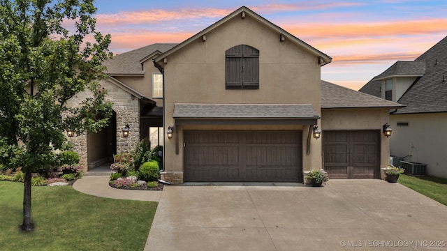 9545 E 108th St S, Bixby, OK 74133 - traditional home featuring driveway, a shingled roof, a front lawn, and stone siding