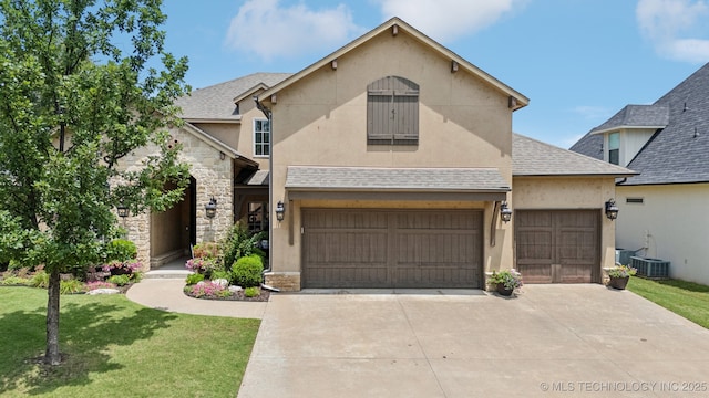 9545 E 108th St S, Bixby, OK 74133 - view of front of home with a front yard, stone siding, stucco siding, and driveway