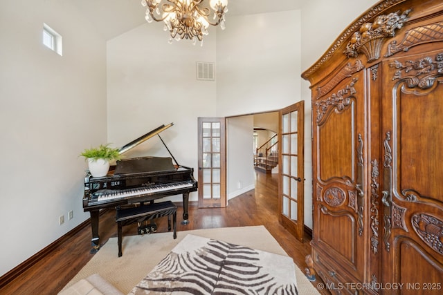 9545 E 108th St S, Bixby, OK 74133 - living area featuring french doors, a chandelier, wood finished floors, high vaulted ceiling, and stairway