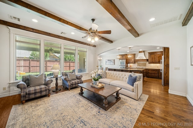 9545 E 108th St S, Bixby, OK 74133 - living room featuring arched walkways, dark wood-style flooring, a ceiling fan, beamed ceiling, and recessed lighting