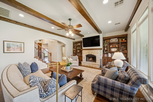 9545 E 108th St S, Bixby, OK 74133 - living room with arched walkways, stairway, ceiling fan, beam ceiling, and a fireplace