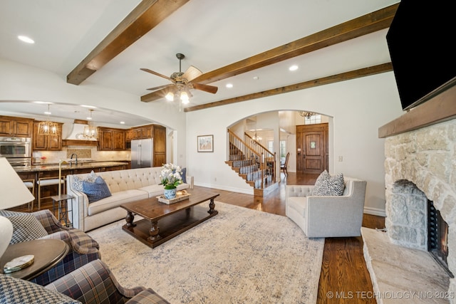 9545 E 108th St S, Bixby, OK 74133 - living area featuring arched walkways, dark wood-type flooring, stairway, a fireplace, and ceiling fan