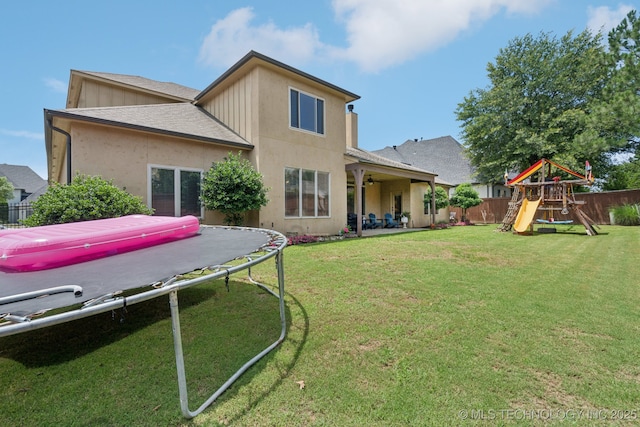 9545 E 108th St S, Bixby, OK 74133 - back of house featuring a fenced backyard, a trampoline, ceiling fan, a playground, and a patio area