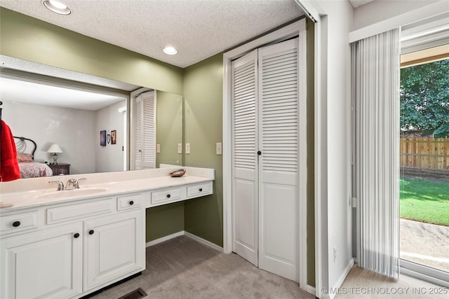 4224 E 84th St, Tulsa, OK 74137 - bathroom with a closet, vanity, a textured ceiling, and recessed lighting