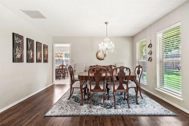 4224 E 84th St, Tulsa, OK 74137 - dining space featuring a chandelier, a textured ceiling, and dark wood-style floors