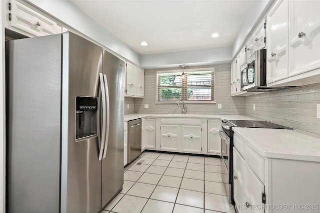 4224 E 84th St, Tulsa, OK 74137 - kitchen featuring stainless steel appliances, light tile patterned floors, light countertops, white cabinets, and recessed lighting