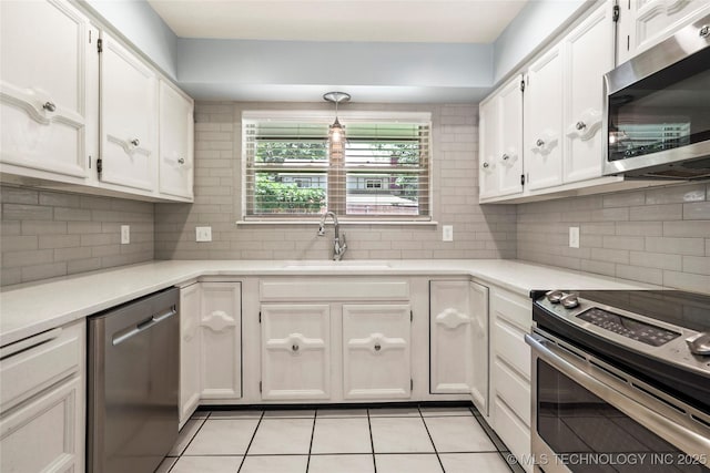 4224 E 84th St, Tulsa, OK 74137 - kitchen featuring stainless steel appliances, light tile patterned flooring, white cabinets, and backsplash