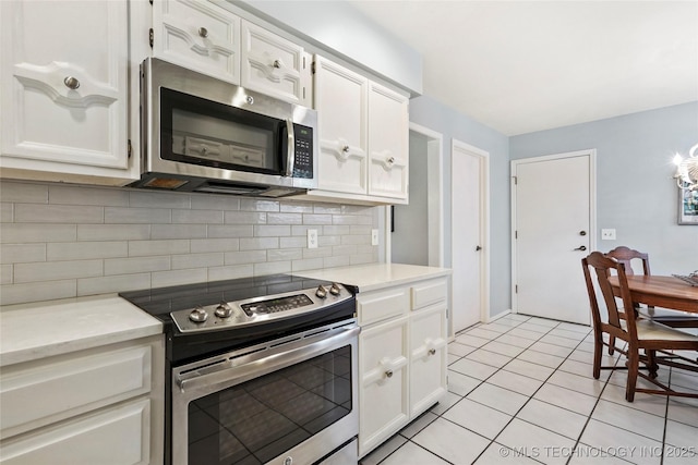 4224 E 84th St, Tulsa, OK 74137 - kitchen featuring appliances with stainless steel finishes, decorative backsplash, light countertops, and white cabinetry