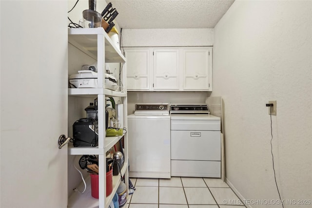 4224 E 84th St, Tulsa, OK 74137 - washroom with cabinet space, washing machine and clothes dryer, a textured ceiling, and light tile patterned flooring