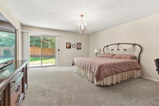 4224 E 84th St, Tulsa, OK 74137 - carpeted bedroom featuring a chandelier, access to exterior, and a textured ceiling