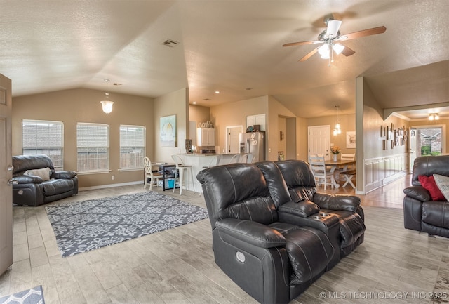 420 W 54th St, Sand Springs, OK 74063 - living room featuring vaulted ceiling, ceiling fan, light wood-style floors, and plenty of natural light