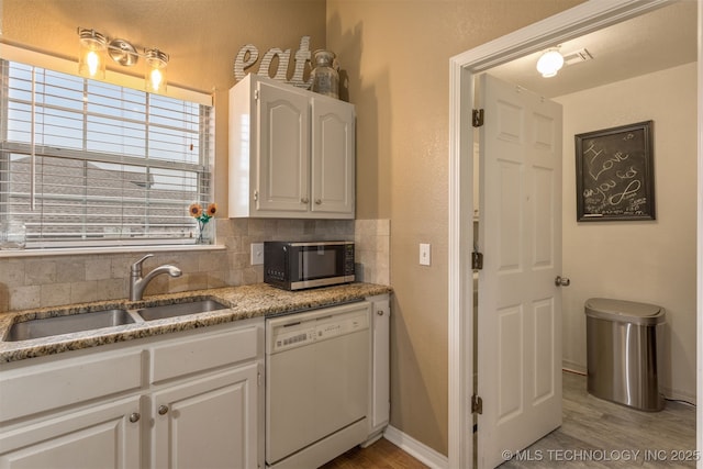420 W 54th St, Sand Springs, OK 74063 - kitchen with white dishwasher, stainless steel microwave, light wood-style floors, and white cabinetry