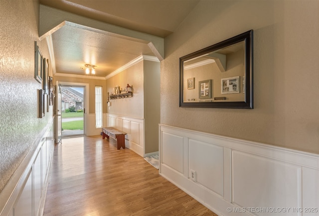 420 W 54th St, Sand Springs, OK 74063 - hallway featuring crown molding, a decorative wall, wood finished floors, wainscoting, and a textured wall