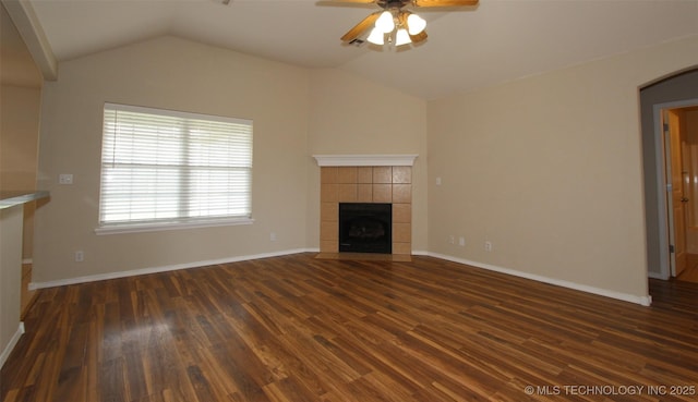 14313 E 112th Pl, Owasso, OK 74055 - unfurnished living room with a ceiling fan, dark wood finished floors, lofted ceiling, a tile fireplace, and arched walkways