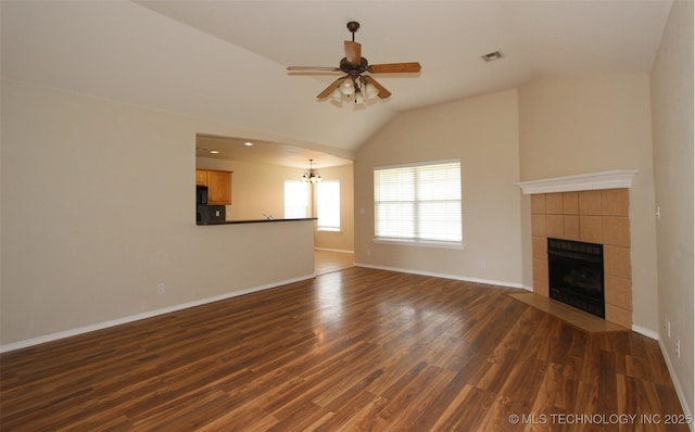 14313 E 112th Pl, Owasso, OK 74055 - unfurnished living room with vaulted ceiling, a fireplace, ceiling fan, dark wood-type flooring, and a chandelier
