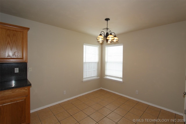 14313 E 112th Pl, Owasso, OK 74055 - unfurnished dining area featuring a chandelier and light tile patterned flooring