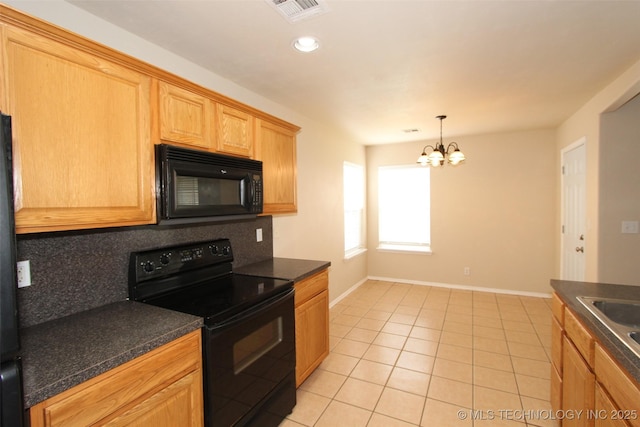 14313 E 112th Pl, Owasso, OK 74055 - kitchen with black appliances, dark countertops, light tile patterned floors, a chandelier, and tasteful backsplash