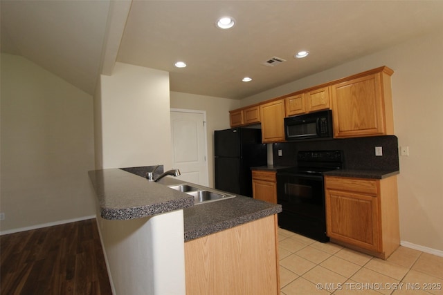 14313 E 112th Pl, Owasso, OK 74055 - kitchen featuring black appliances, dark countertops, a peninsula, recessed lighting, and light tile patterned floors