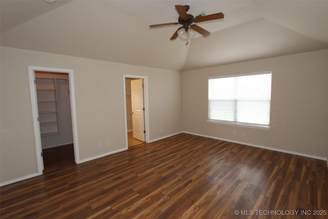 14313 E 112th Pl, Owasso, OK 74055 - unfurnished bedroom with vaulted ceiling, a spacious closet, dark wood-style floors, a closet, and ceiling fan