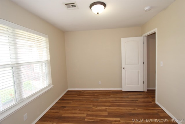 14313 E 112th Pl, Owasso, OK 74055 - empty room featuring plenty of natural light, a smoke detector, and wood finished floors