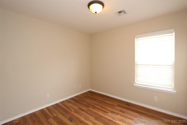 14313 E 112th Pl, Owasso, OK 74055 - spare room featuring plenty of natural light and dark wood-style flooring