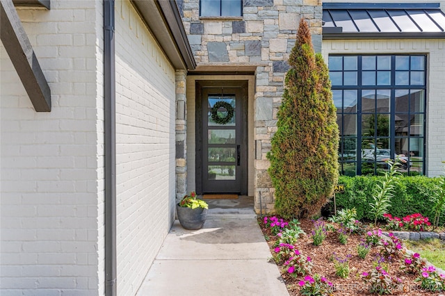 10470 E 123rd Pl S, Bixby, OK 74008 - doorway to property featuring a standing seam roof, a metal roof, and brick siding