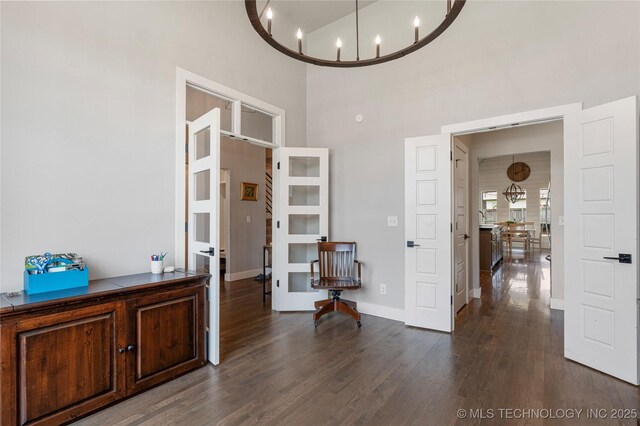 10470 E 123rd Pl S, Bixby, OK 74008 - interior space with a high ceiling, dark wood-style floors, a desk, and a chandelier