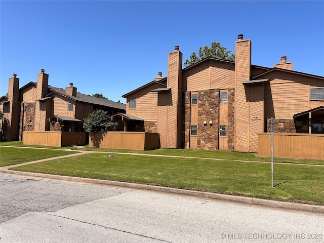 3402 S Winston Ave Unit 103, Tulsa, OK 74135 - view of side of home featuring stone siding and a chimney