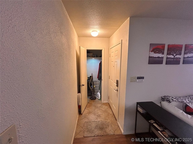 3402 S Winston Ave Unit 103, Tulsa, OK 74135 - corridor with a textured ceiling, a textured wall, and light tile patterned floors