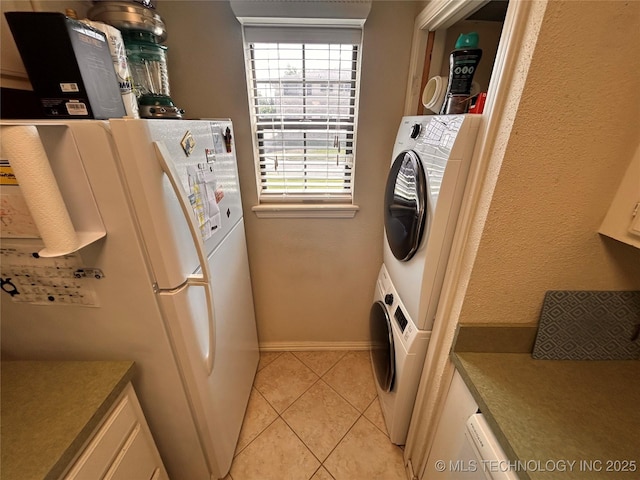 3402 S Winston Ave Unit 103, Tulsa, OK 74135 - washroom featuring light tile patterned floors and stacked washer and clothes dryer