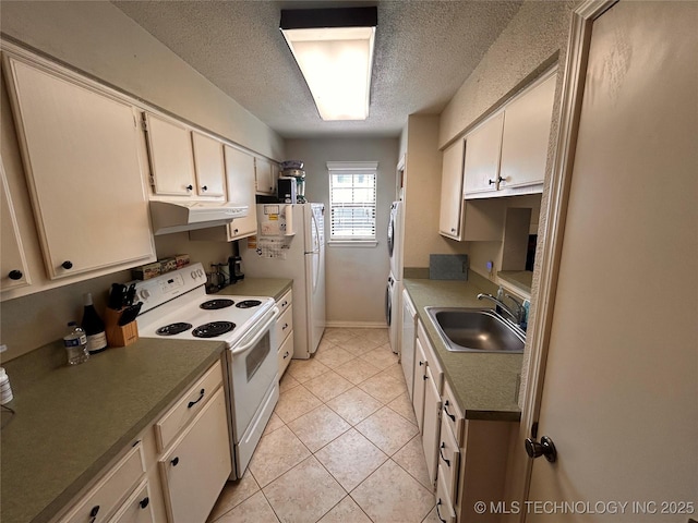 3402 S Winston Ave Unit 103, Tulsa, OK 74135 - kitchen featuring white appliances, under cabinet range hood, a textured ceiling, light tile patterned flooring, and washer / clothes dryer