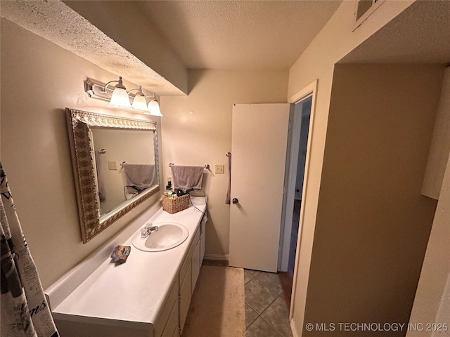 3402 S Winston Ave Unit 103, Tulsa, OK 74135 - bathroom with a textured ceiling and vanity