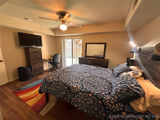 3402 S Winston Ave Unit 103, Tulsa, OK 74135 - bedroom with access to exterior, wood finished floors, a textured ceiling, and a ceiling fan