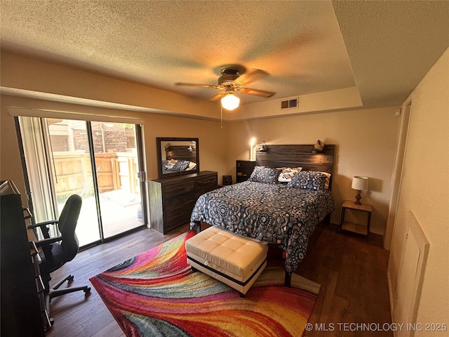 3402 S Winston Ave Unit 103, Tulsa, OK 74135 - bedroom featuring access to outside, a textured ceiling, wood finished floors, an office area, and ceiling fan