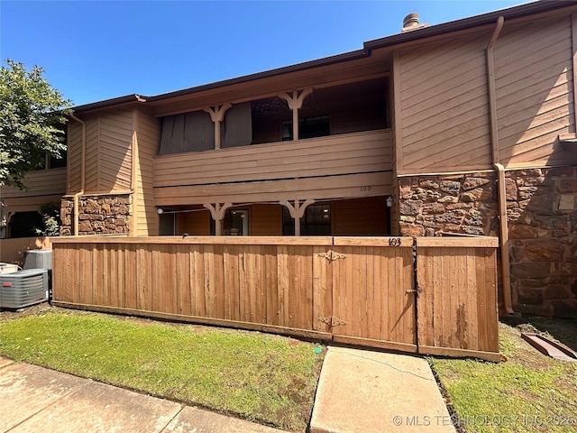 3402 S Winston Ave Unit 103, Tulsa, OK 74135 - back of property with a balcony and stone siding